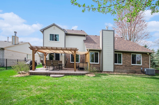back of house featuring central AC, fence, a pergola, brick siding, and a lawn
