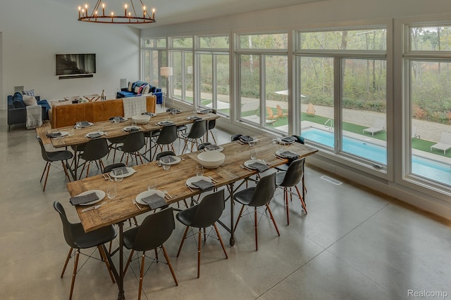 10630 Garr Rd, Berrien Springs, MI 49103 - dining area featuring finished concrete floors, plenty of natural light, and a chandelier