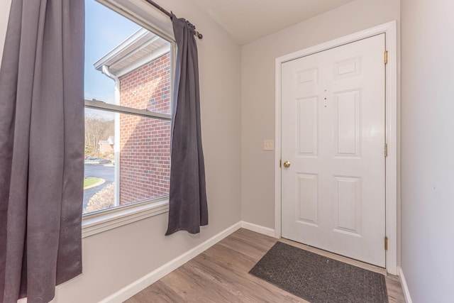 1005 E Duncan St Unit 2D, Manchester, MI 48158 - doorway to outside with baseboards and wood finished floors