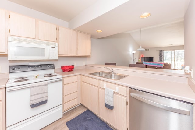 1005 E Duncan St Unit 2D, Manchester, MI 48158 - kitchen with light brown cabinets, a sink, light wood-style floors, white appliances, and light countertops