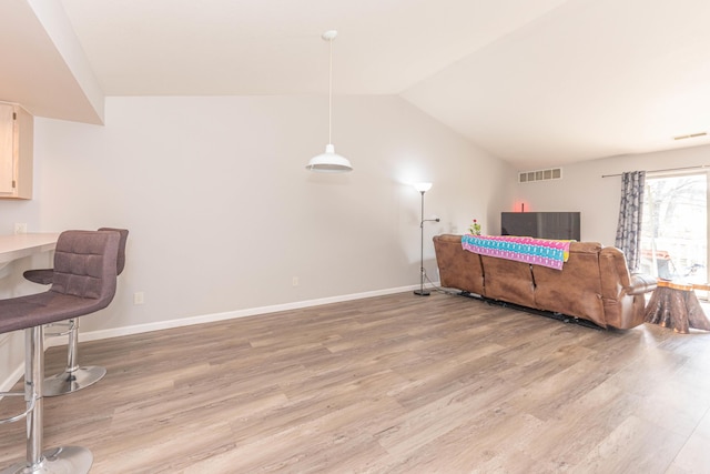 1005 E Duncan St Unit 2D, Manchester, MI 48158 - interior space featuring light wood-style flooring, visible vents, lofted ceiling, and baseboards