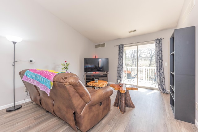 1005 E Duncan St Unit 2D, Manchester, MI 48158 - living area featuring wood finished floors, visible vents, and baseboards