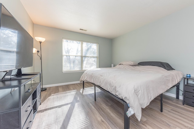 1005 E Duncan St Unit 2D, Manchester, MI 48158 - bedroom featuring baseboards, wood finished floors, and visible vents