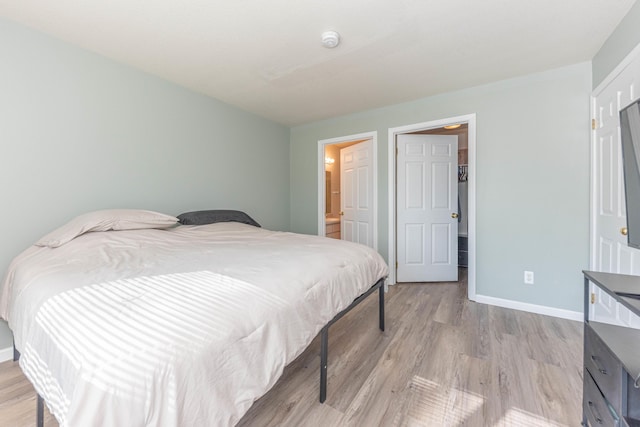 1005 E Duncan St Unit 2D, Manchester, MI 48158 - bedroom with light wood-type flooring and baseboards