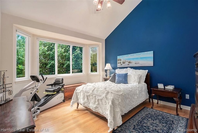 bedroom featuring lofted ceiling, a ceiling fan, and wood finished floors