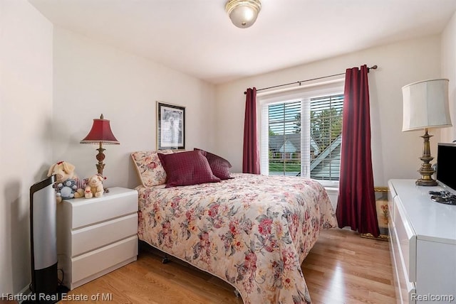 bedroom with light wood finished floors