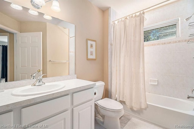 bathroom with shower / tub combo, vanity, tile patterned flooring, and toilet