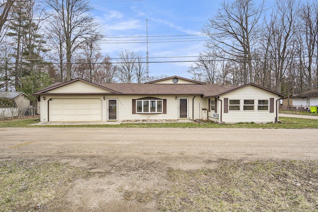 4302 Lake Dr, Beaverton, MI 48612 - ranch-style home with a shingled roof, driveway, and a garage