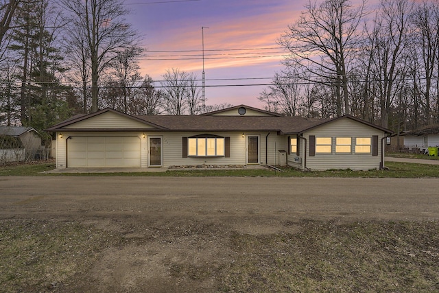 4302 Lake Dr, Beaverton, MI 48612 - view of front of home featuring driveway, roof with shingles, and a garage