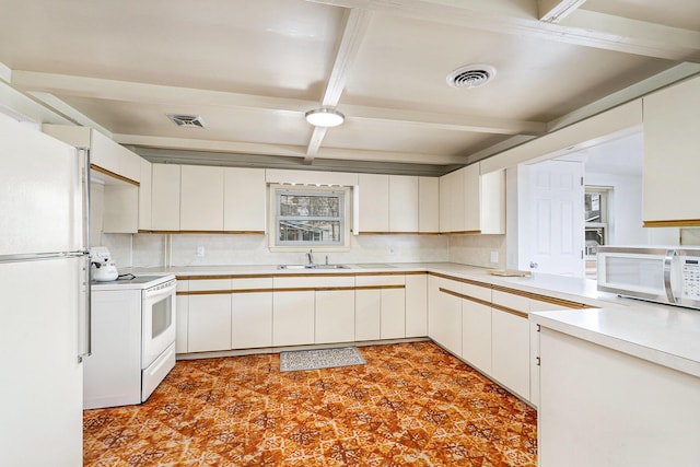 4302 Lake Dr, Beaverton, MI 48612 - kitchen featuring tasteful backsplash, white appliances, light countertops, coffered ceiling, and visible vents