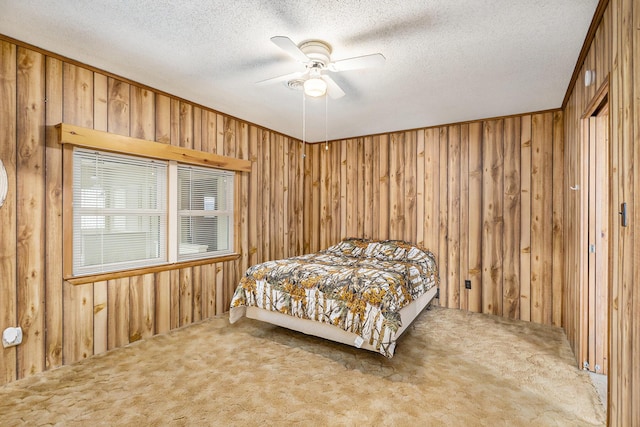 4302 Lake Dr, Beaverton, MI 48612 - bedroom featuring carpet flooring, a textured ceiling, wood walls, and a ceiling fan