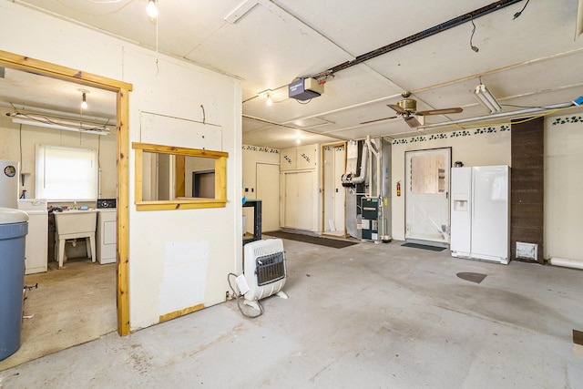 4302 Lake Dr, Beaverton, MI 48612 - garage featuring a sink, a garage door opener, heating unit, white fridge with ice dispenser, and washer / dryer