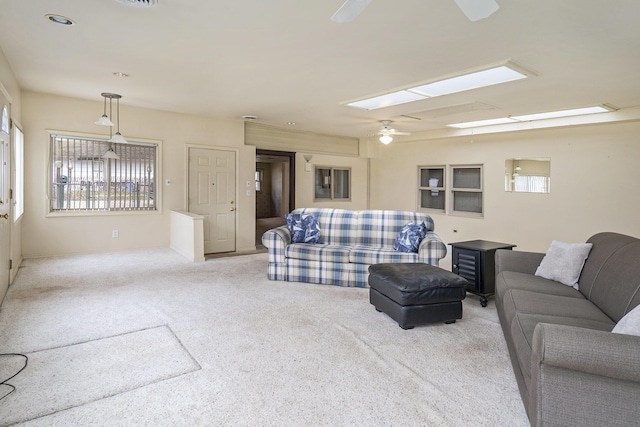 4302 Lake Dr, Beaverton, MI 48612 - living area with a skylight, carpet floors, ceiling fan, and a healthy amount of sunlight