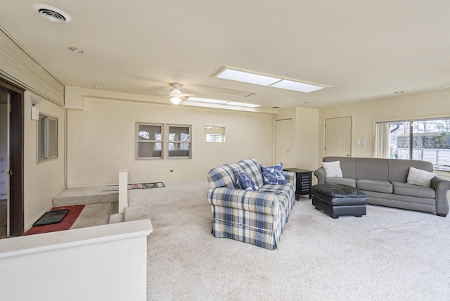 4302 Lake Dr, Beaverton, MI 48612 - carpeted living room featuring a skylight, a ceiling fan, and visible vents