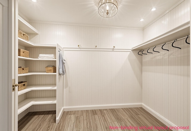 4302 Lake Dr, Beaverton, MI 48612 - spacious closet with wood finished floors and an inviting chandelier