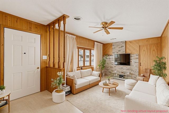 4302 Lake Dr, Beaverton, MI 48612 - living room with visible vents, wood walls, ceiling fan, and light colored carpet