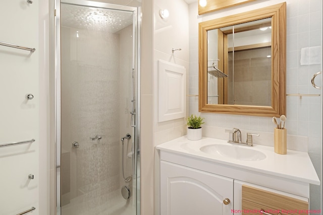 4302 Lake Dr, Beaverton, MI 48612 - full bathroom with tasteful backsplash, a shower stall, tile walls, and vanity