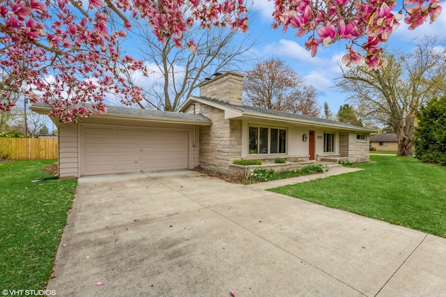 3105 Kevin St, Saint Joseph, MI 49085 - ranch-style house with concrete driveway, fence, stone siding, and a front yard
