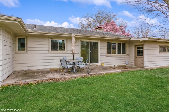3105 Kevin St, Saint Joseph, MI 49085 - rear view of property with a lawn, a chimney, roof with shingles, and a patio area