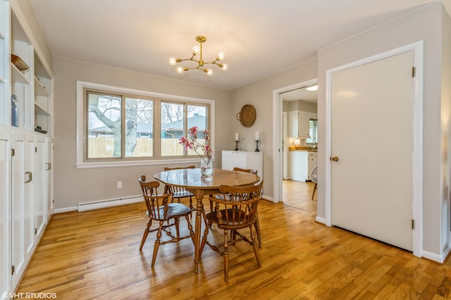 3105 Kevin St, Saint Joseph, MI 49085 - dining area with a baseboard heating unit, an inviting chandelier, light wood-style floors, and baseboards