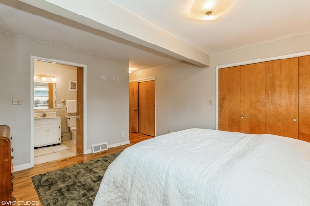 3105 Kevin St, Saint Joseph, MI 49085 - bedroom featuring wood finished floors, a sink, connected bathroom, two closets, and visible vents