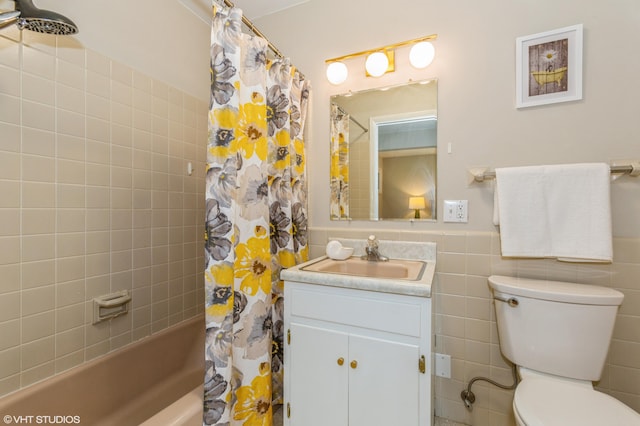 3105 Kevin St, Saint Joseph, MI 49085 - bathroom featuring a wainscoted wall, shower / bath combination with curtain, toilet, vanity, and tile walls