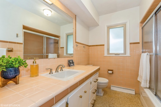 3105 Kevin St, Saint Joseph, MI 49085 - full bath with a wainscoted wall, a shower with door, toilet, vanity, and tile walls