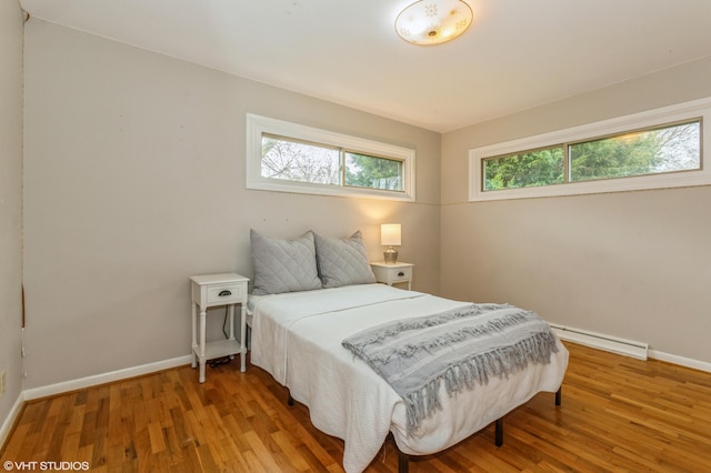 3105 Kevin St, Saint Joseph, MI 49085 - bedroom featuring baseboard heating, baseboards, and multiple windows