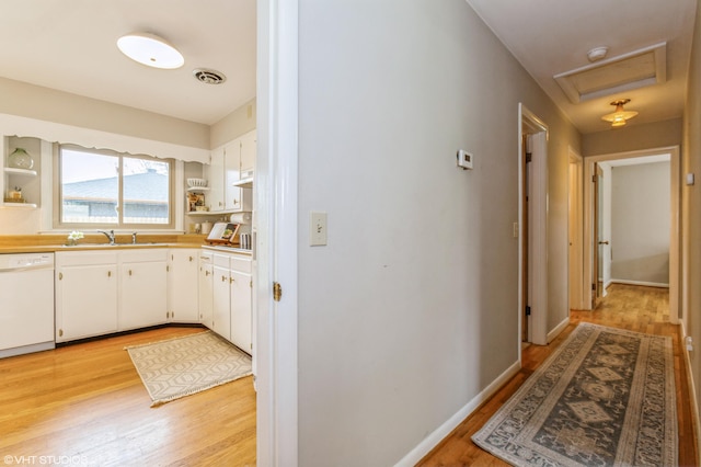 3105 Kevin St, Saint Joseph, MI 49085 - corridor featuring attic access, a sink, visible vents, and light wood-type flooring
