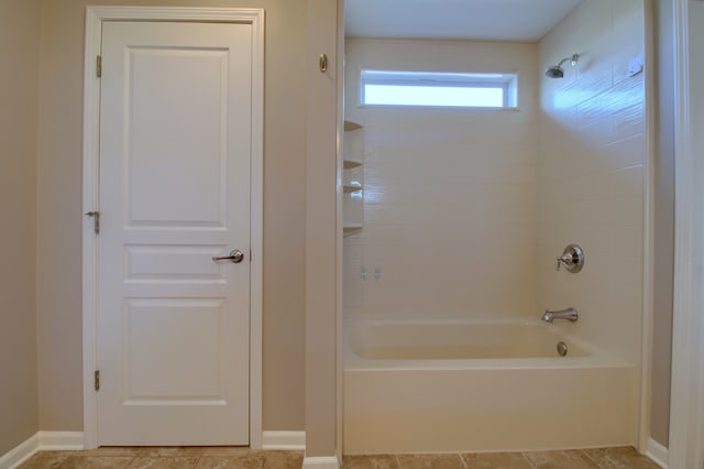 full bath featuring tile patterned floors, baseboards, and bathing tub / shower combination