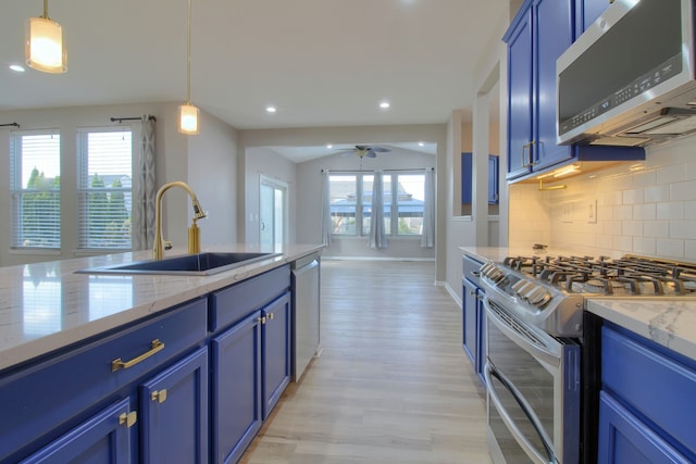 kitchen featuring blue cabinets, appliances with stainless steel finishes, and a sink