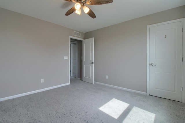 unfurnished bedroom with visible vents, baseboards, a ceiling fan, and light carpet