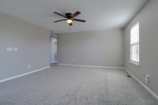 unfurnished room with ceiling fan, baseboards, carpet, and a healthy amount of sunlight