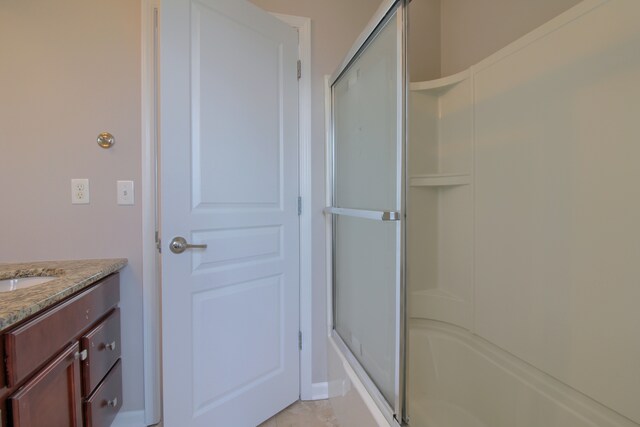 full bathroom featuring tile patterned floors and vanity