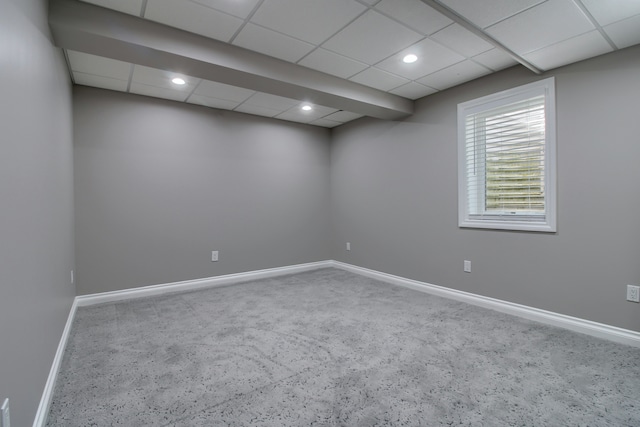 spare room with a drop ceiling, recessed lighting, carpet flooring, and baseboards