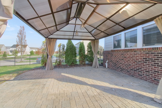view of patio with fence and a gazebo