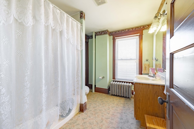 full bath featuring visible vents, baseboards, toilet, radiator heating unit, and vanity
