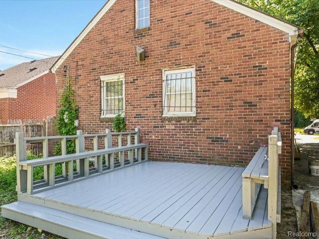 wooden terrace featuring fence