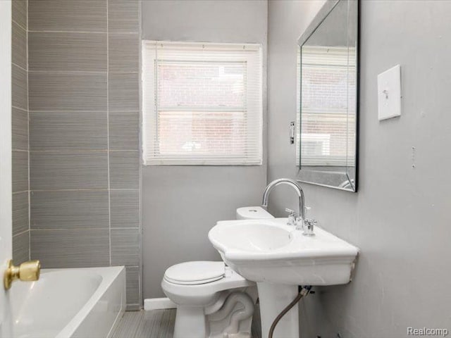 full bath featuring toilet, walk in shower, a bathtub, and baseboards