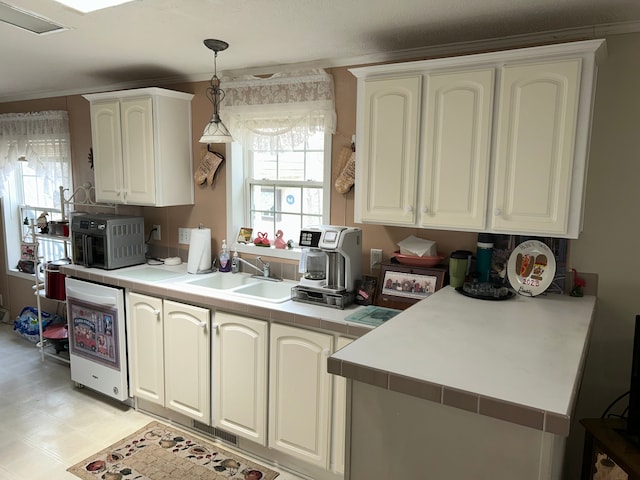 326 Basket Br, Oxford, MI 48371 - kitchen with light floors, visible vents, tile countertops, crown molding, and hanging light fixtures