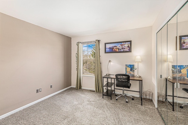 carpeted home office featuring baseboards