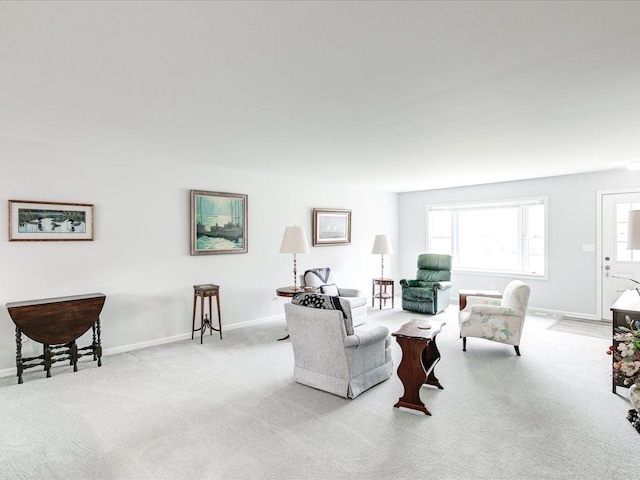 living room with baseboards and carpet