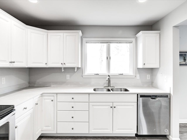 kitchen featuring light countertops, a sink, appliances with stainless steel finishes, and white cabinetry