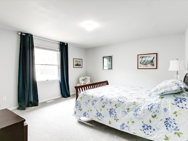 carpeted bedroom featuring visible vents, baseboards, and multiple windows