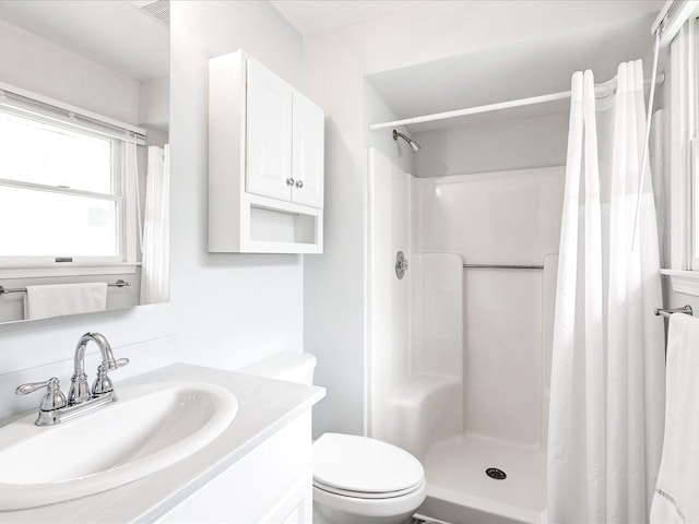 bathroom featuring visible vents, curtained shower, toilet, and vanity
