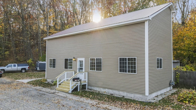 view of front facade with cooling unit and metal roof