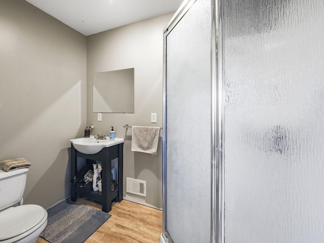 full bathroom with visible vents, toilet, a stall shower, and vanity