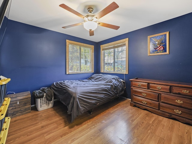 bedroom featuring a ceiling fan and wood finished floors