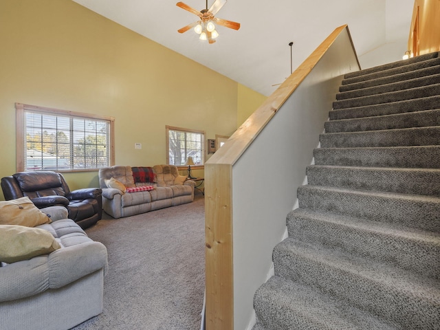 living room featuring carpet, high vaulted ceiling, stairs, and ceiling fan