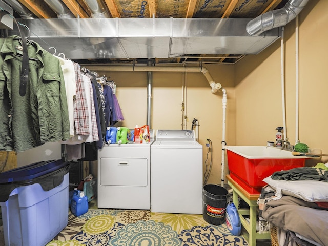 laundry area featuring washing machine and dryer, a sink, and laundry area